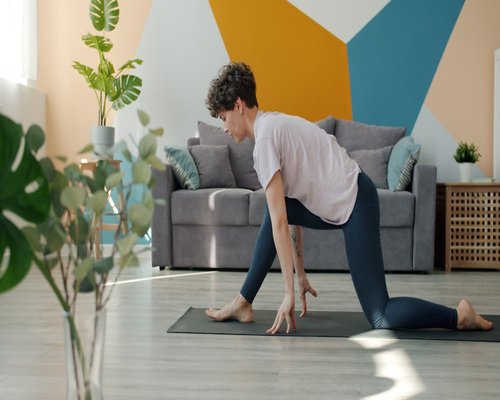 woman doing gentle stretching in her living room in the morning